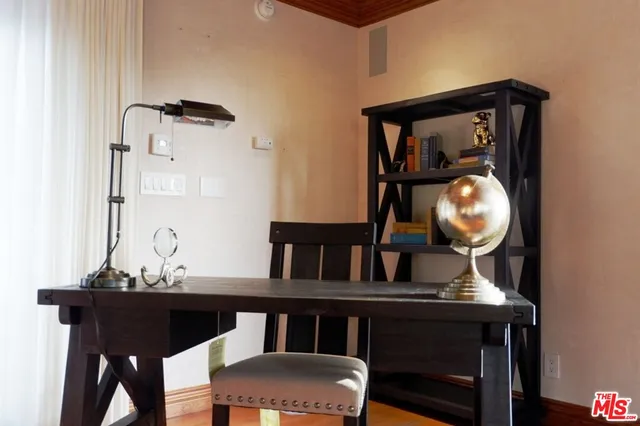 a view of house with a yard and potted plants