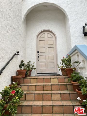 a view of balcony with table and chairs and potted plants