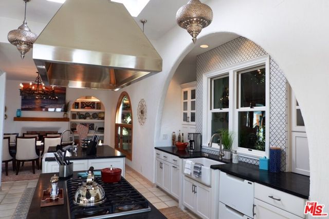 a kitchen with a sink and large windows