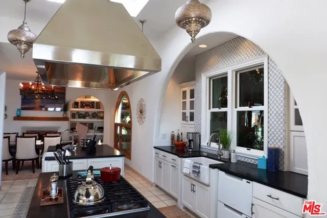 a kitchen with a sink and large windows