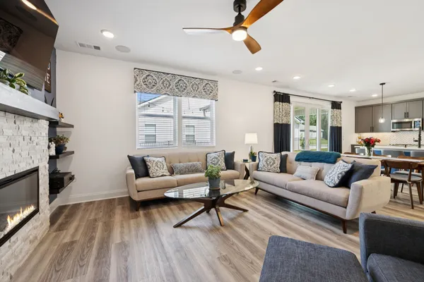a living room with furniture and a wooden floor