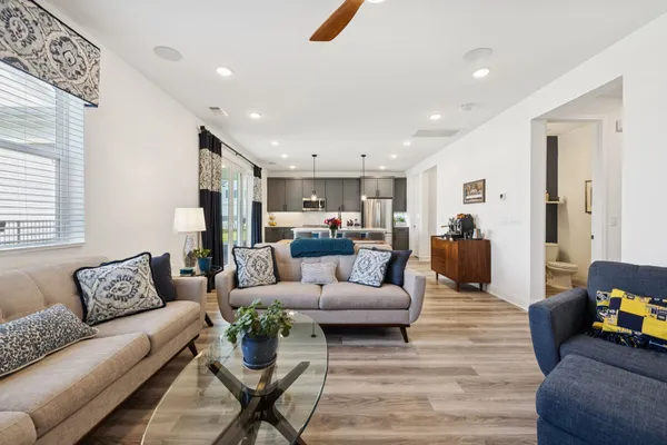 a living room with furniture or kitchen view and a wooden floor