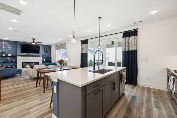 a kitchen with stainless steel appliances granite countertop a sink a stove and a refrigerator