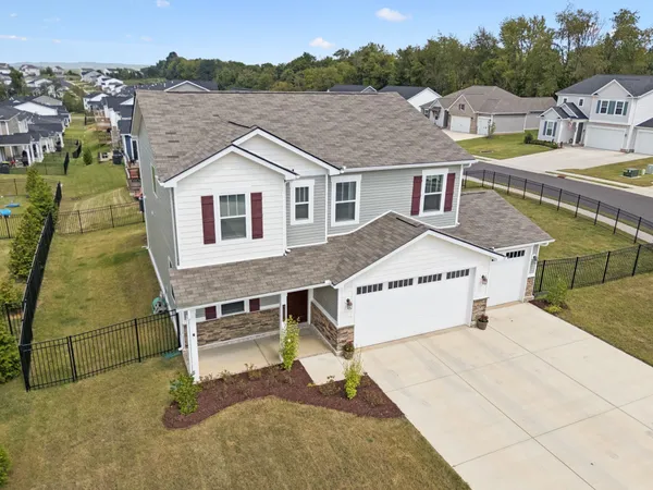 an aerial view of a house with a yard