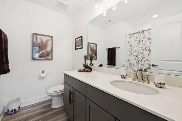 a bathroom with a sink toilet and a mirror