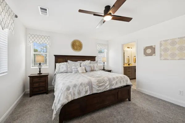 a spacious bedroom with a bed and a table