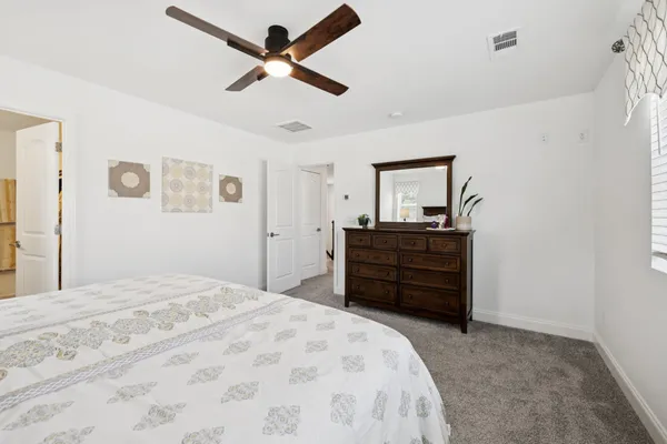 a bed room with a bed and a dresser