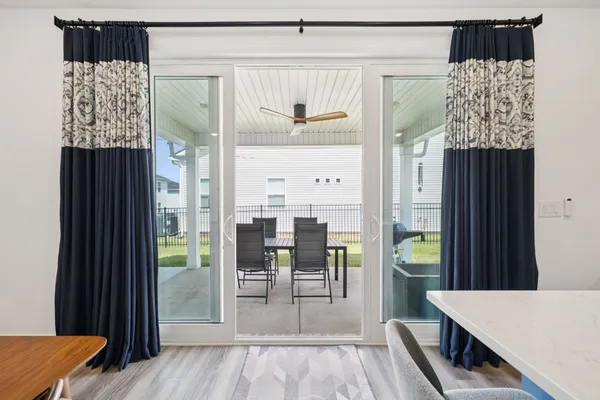 a dining room with furniture and a wooden floor