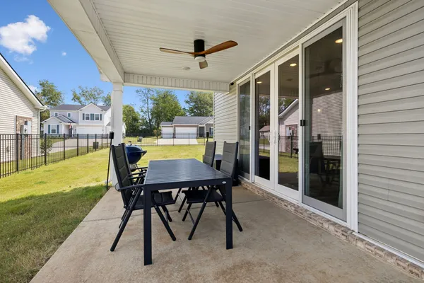 a view of a patio with a table and chairs