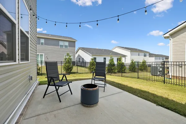 a view of a patio with a table and chairs