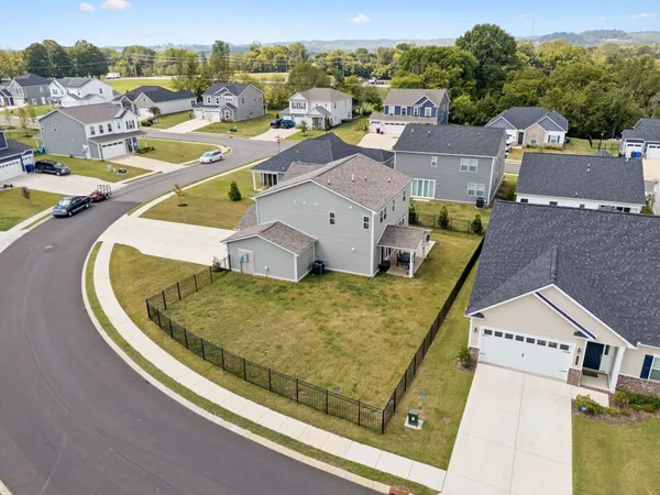 an aerial view of a house with a swimming pool