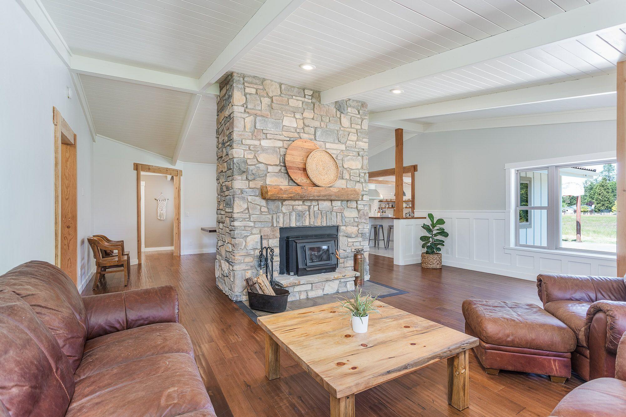 3134 South River Road Grants Pass, OR 97527 - Photo 7 of 38 a living room with furniture and a fireplace