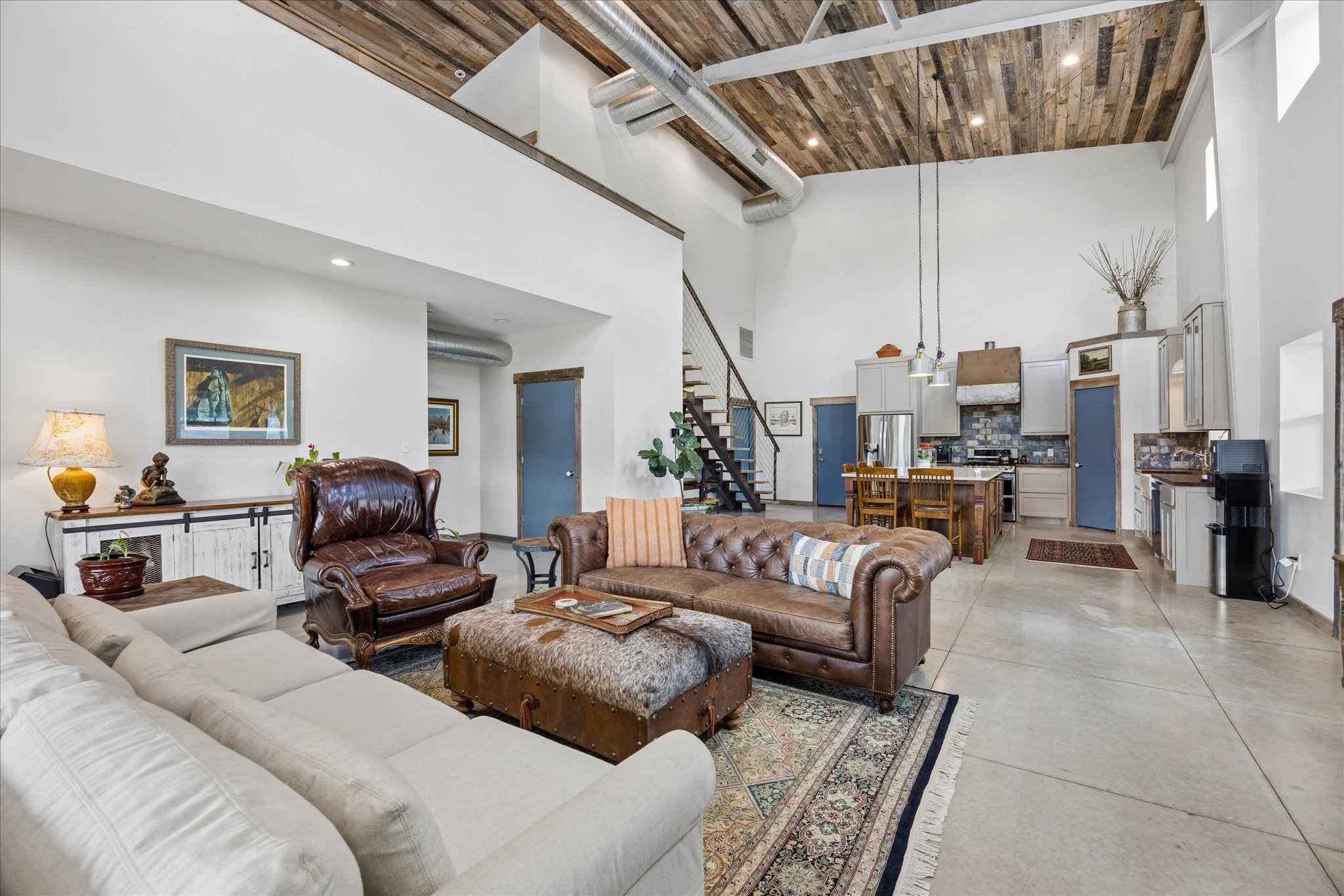 6411 West Fitzhugh Road Dripping Springs, TX 78620 - Photo 12 of 34 Spacious open-concept living area featuring high ceilings with wood paneling
