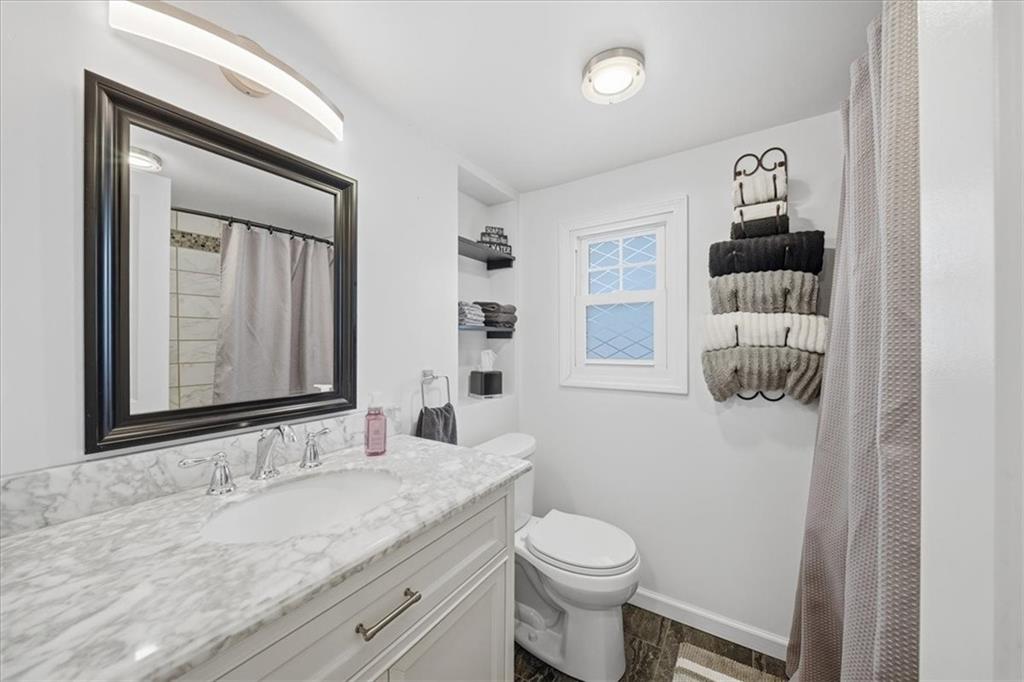 1400 Hamilton Road Pittsburgh, PA 15234 - Photo 23 of 36 a bathroom with a granite countertop sink and a mirror