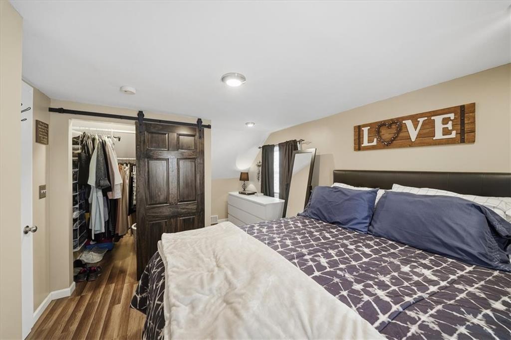 1400 Hamilton Road Pittsburgh, PA 15234 - Photo 26 of 36 a bedroom with a large bed and a walk in closet