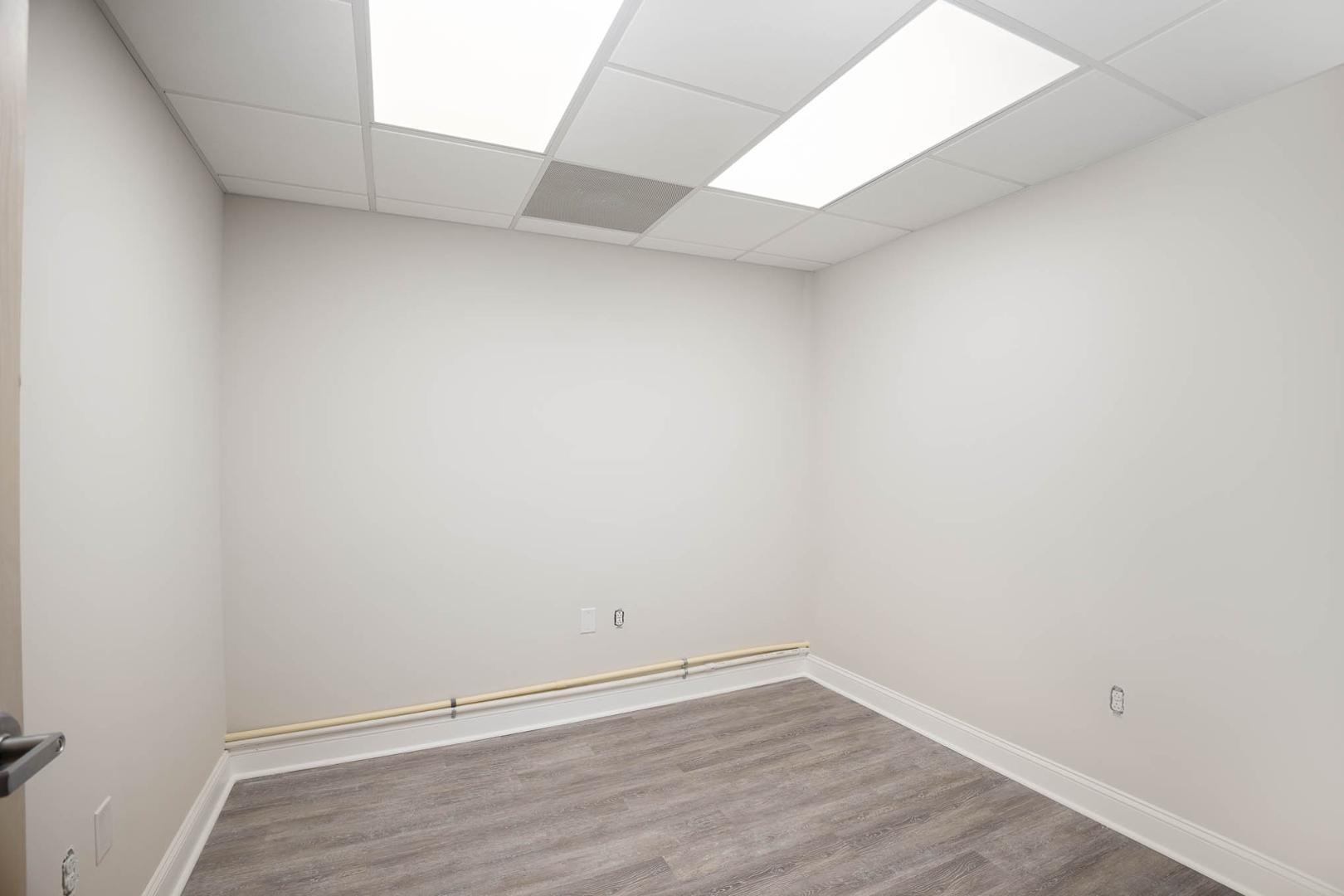 5621 Departure Drive, Unit 101 Raleigh, NC 27616 - Photo 10 of 17 a view of an empty room with wooden floor