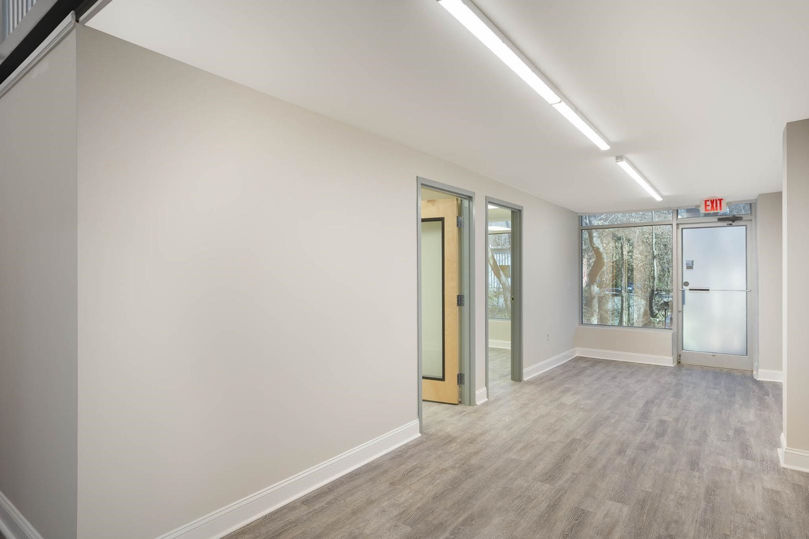 5621 Departure Drive, Unit 101 Raleigh, NC 27616 - Photo 5 of 17 a view of an empty room with wooden floor and a window