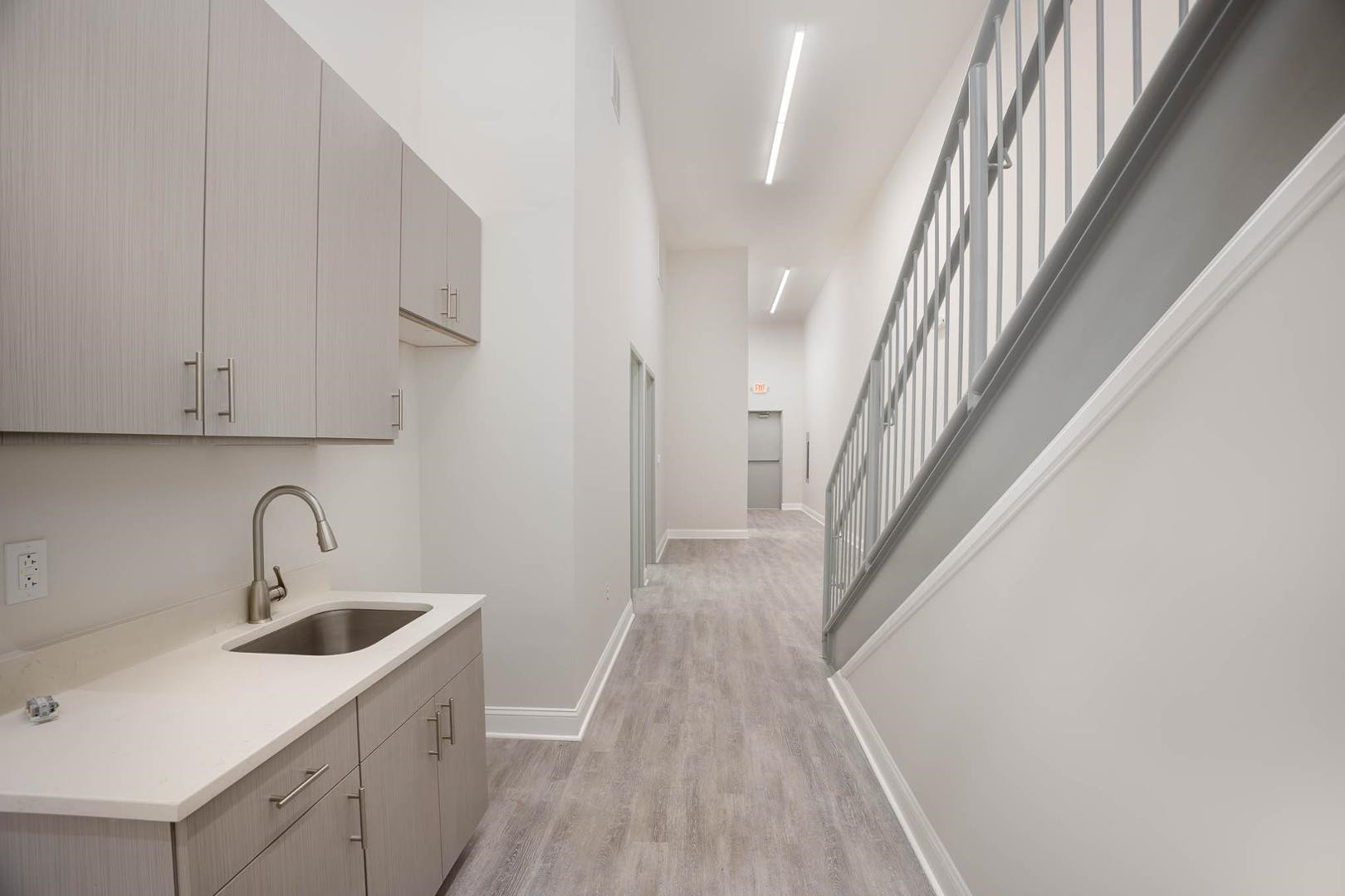 5621 Departure Drive, Unit 101 Raleigh, NC 27616 - Photo 6 of 17 a kitchen with a sink a refrigerator and cabinets