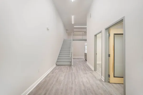 a kitchen with a sink a refrigerator and cabinets