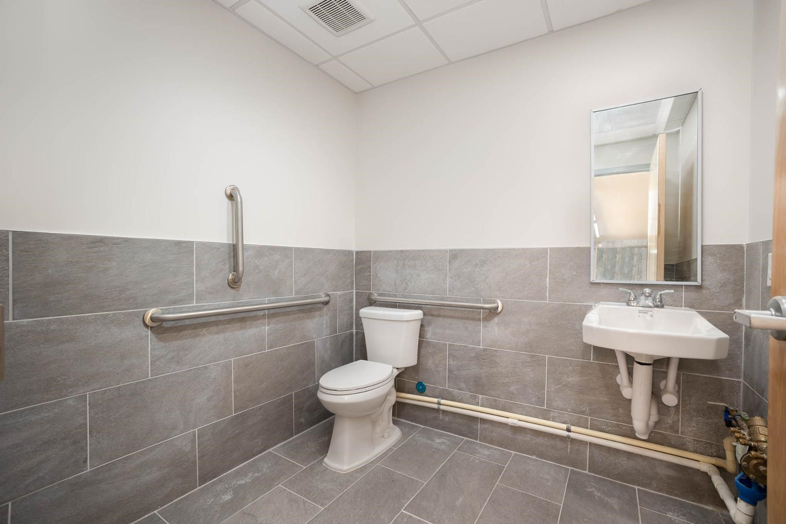 5621 Departure Drive, Unit 101 Raleigh, NC 27616 - Photo 8 of 17 a bathroom with a toilet sink and mirror