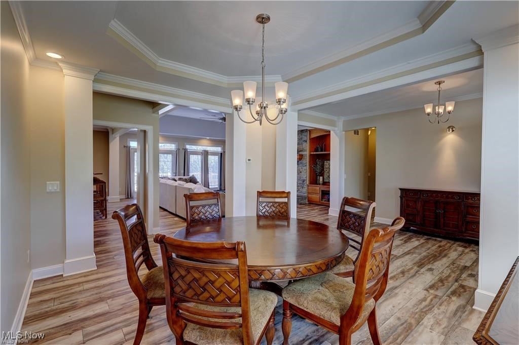 3079 Alexander Road Atwater, OH 44201 - Photo 6 of 45 Dining area featuring a chandelier, a tray ceiling, light wood-style flooring, and ornamental molding