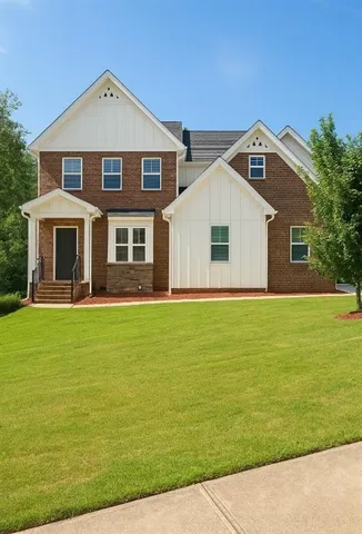 a front view of a house with a garden