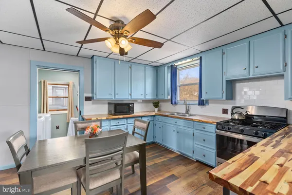 a kitchen with a stove a sink and cabinets