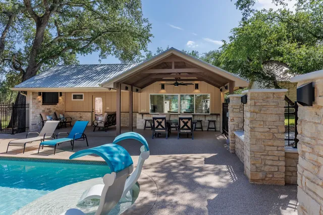 a view of a chairs and tables in the patio and a garden