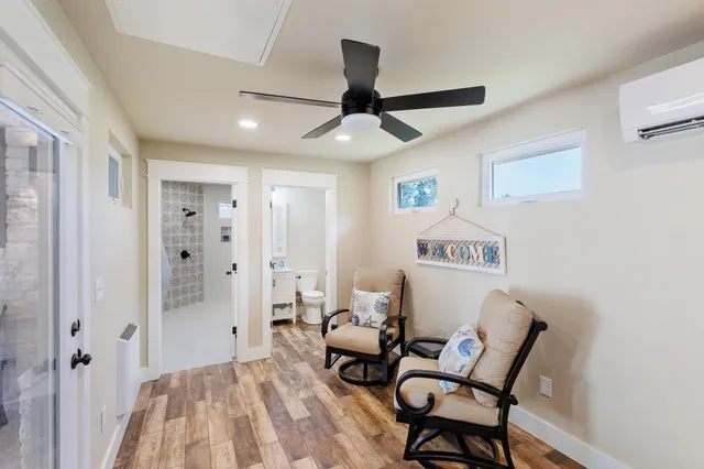 a bedroom with furniture and a ceiling fan