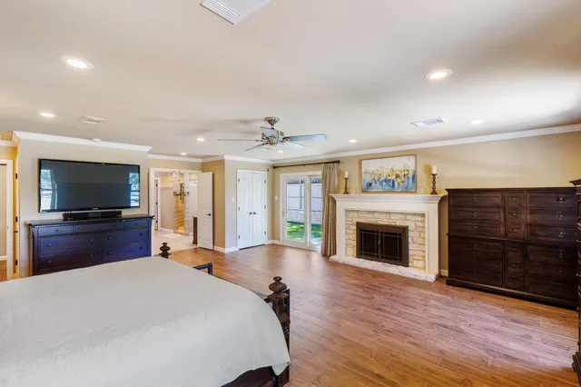 a large bedroom with bed and a flat screen tv