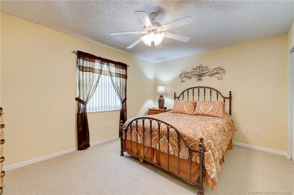 1881 Southwest Palm City Road, Unit H102 Stuart, FL 34994 - Photo 15 of 30 a bedroom with a bed and a window