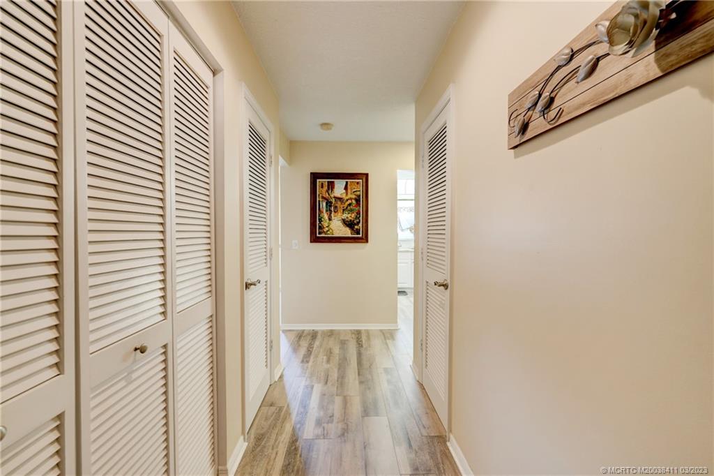 1881 Southwest Palm City Road, Unit H102 Stuart, FL 34994 - Photo 21 of 30 a view of a hallway with wooden floor