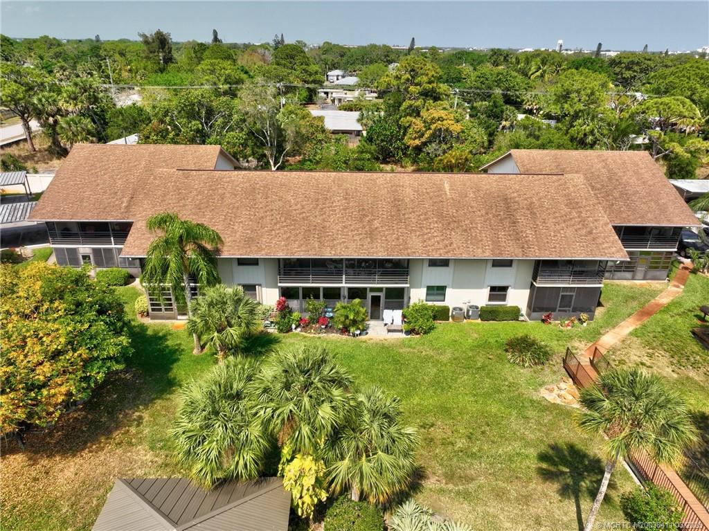 1881 Southwest Palm City Road, Unit H102 Stuart, FL 34994 - Photo 30 of 30 an aerial view of a house with yard and green space