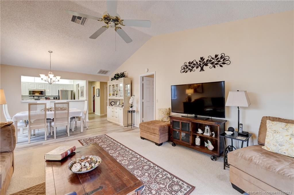 1881 Southwest Palm City Road, Unit H102 Stuart, FL 34994 - Photo 7 of 30 a living room with furniture and a flat screen tv