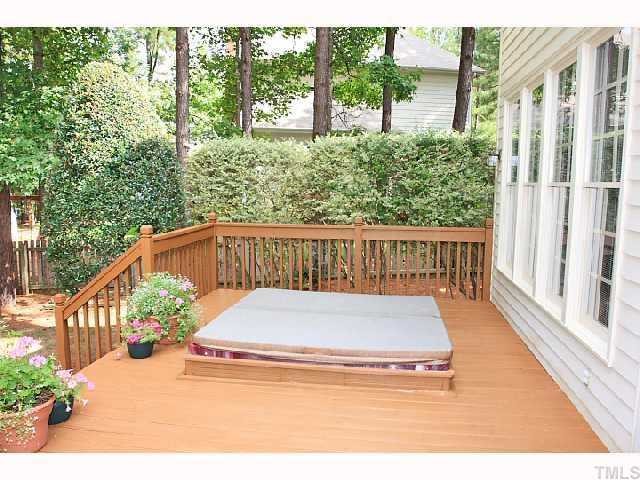 7016 Spring Ridge Road Cary, NC 27518 - Photo 9 of 9 The large 33' X 12' deck is a perfect place for entertaining & grilling or reading & relaxing in the built-in spa. The natural beauty of the private fenced backyard makes a perfect retreat!