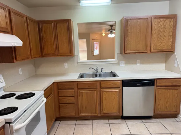 a kitchen with stainless steel appliances a stove a sink and a microwave