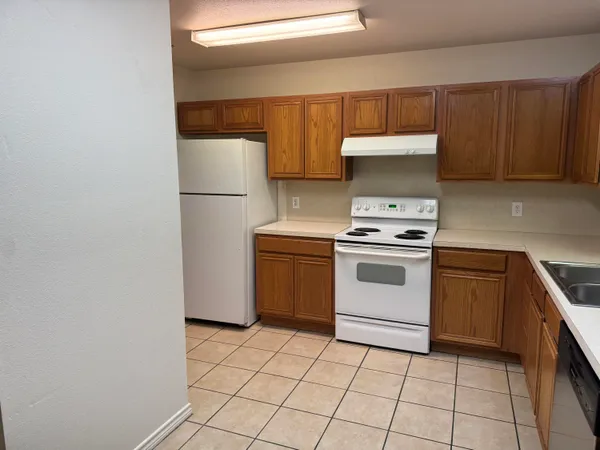 a kitchen with a stove a sink and a refrigerator