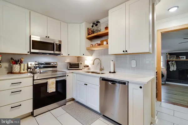 a kitchen with cabinets stainless steel appliances and a sink