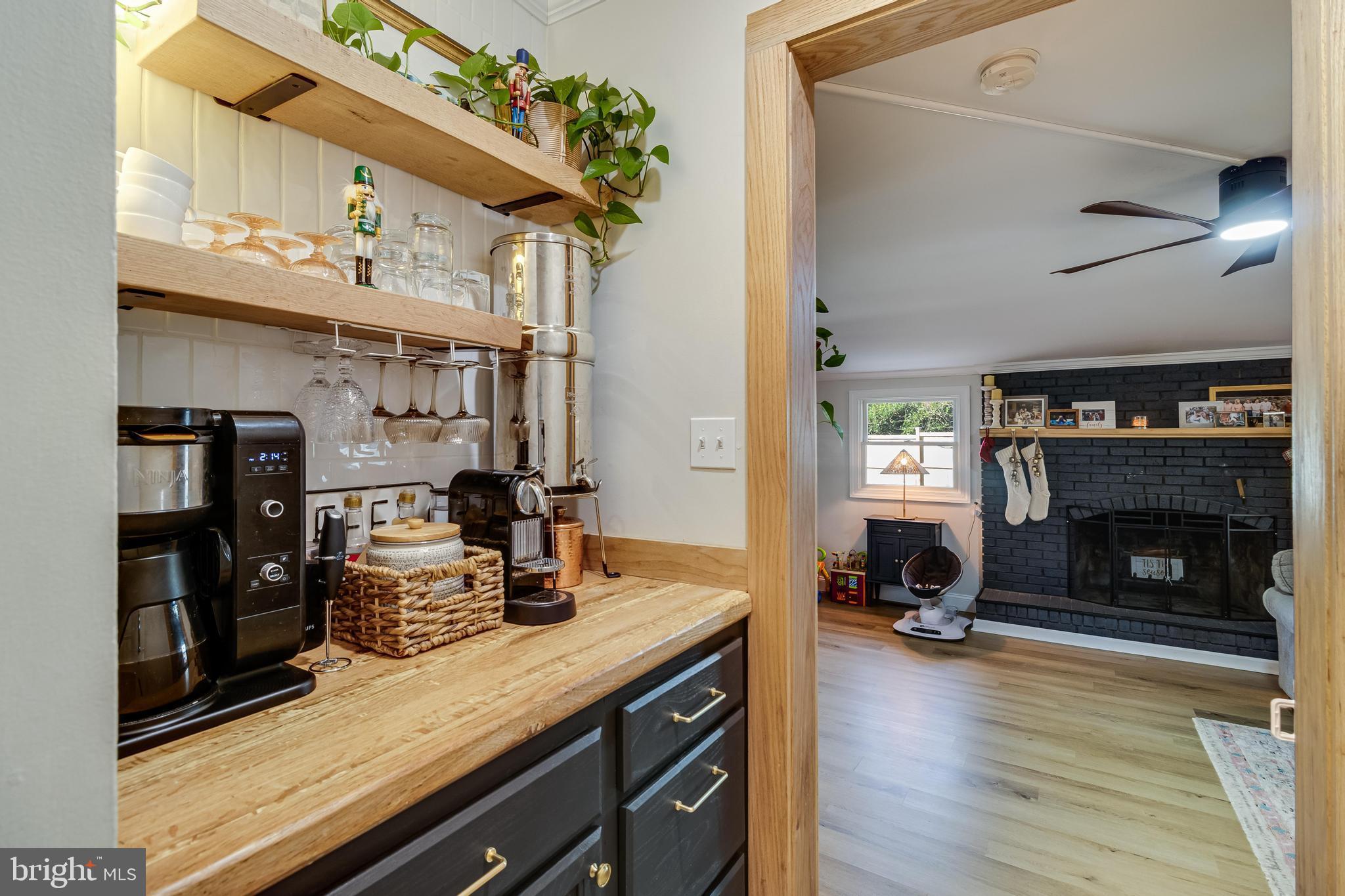 40905 Spring House Lane Leonardtown, MD 20650 - Photo 14 of 50 a kitchen with stainless steel appliances granite countertop a stove refrigerator and a fireplace with the bookshelf