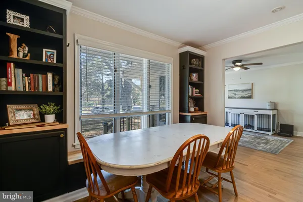 a dining room with furniture window and wooden floor