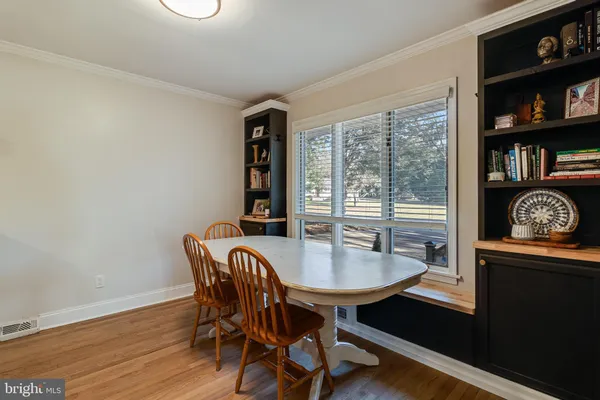 a dining room with furniture and wooden floor
