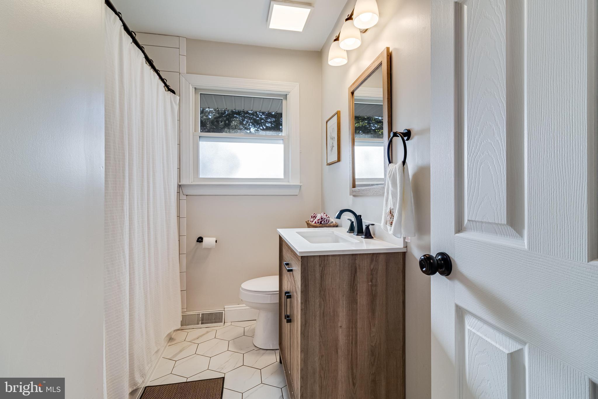 40905 Spring House Lane Leonardtown, MD 20650 - Photo 22 of 50 a bathroom with a granite countertop sink toilet and shower