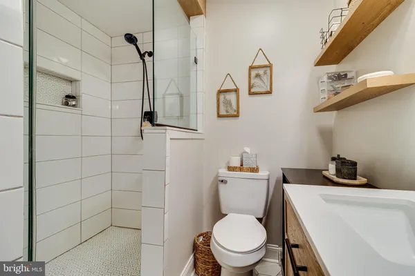 a white toilet sitting next to a bathroom sink