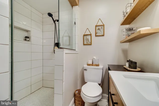a white toilet sitting next to a bathroom sink
