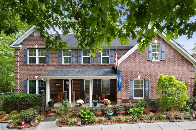 front view of a brick house with a large window
