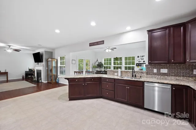 a large kitchen with lots of counter space and sink