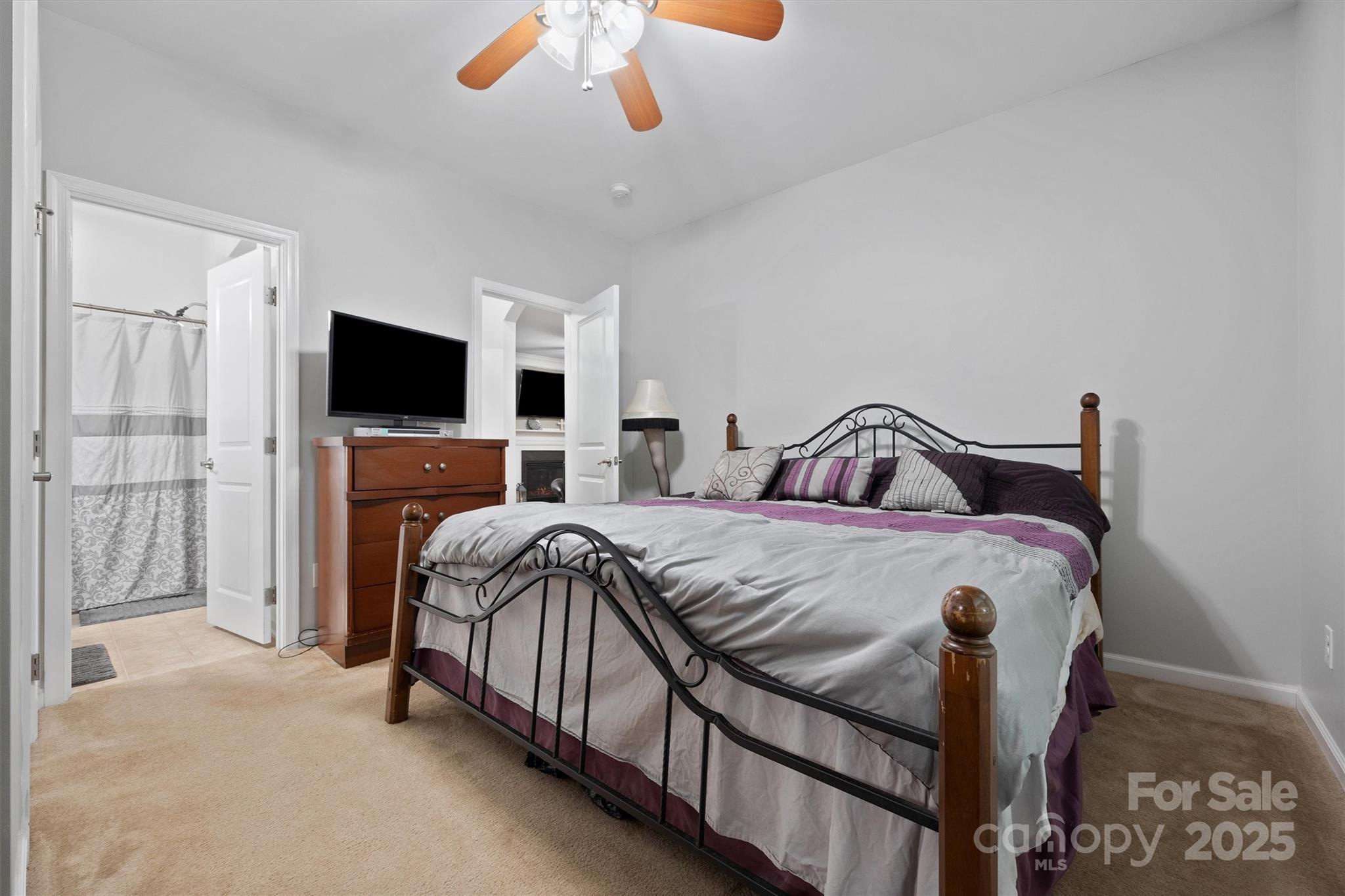 4237 Little Fork Cove Road Denver, NC 28037 - Photo 15 of 38 a bedroom with a bed and a flat screen tv