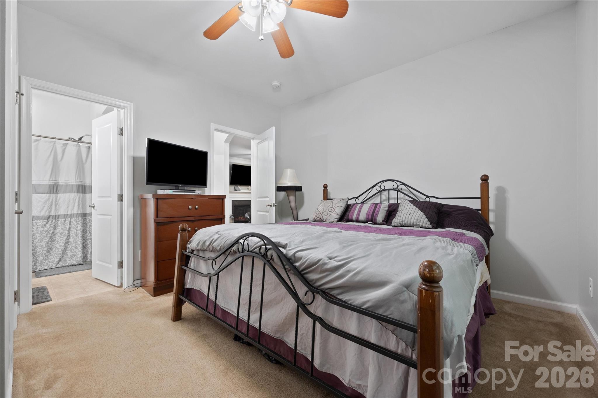 4237 Little Fork Cove Road Denver, NC 28037 - Photo 16 of 40 a bedroom with a bed and a flat screen tv