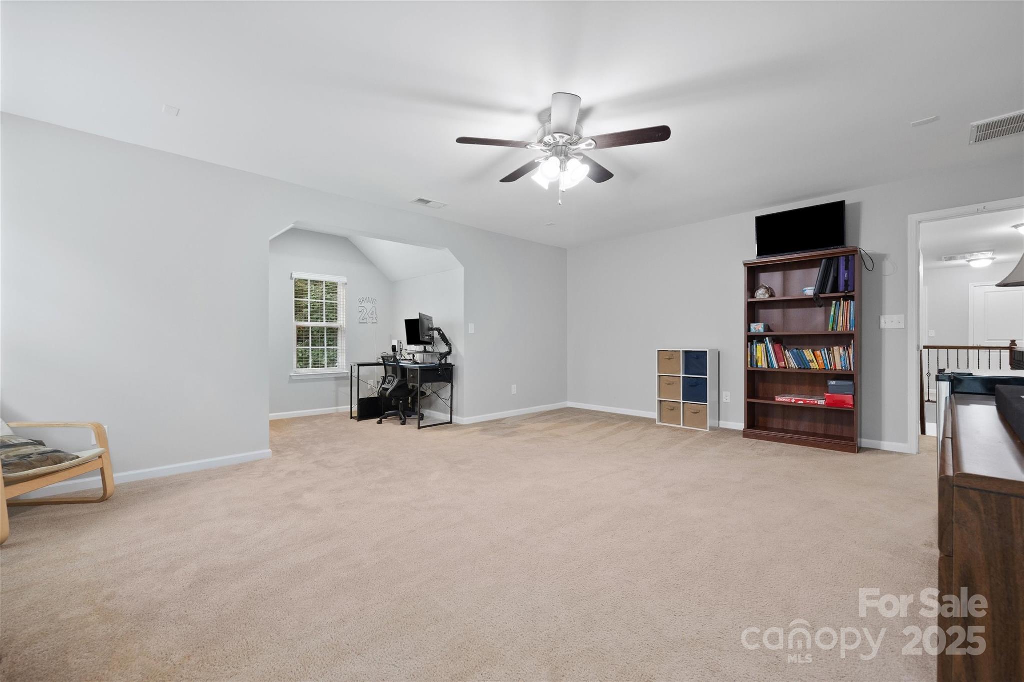 4237 Little Fork Cove Road Denver, NC 28037 - Photo 17 of 38 a view of a livingroom with a bookshelf and a window