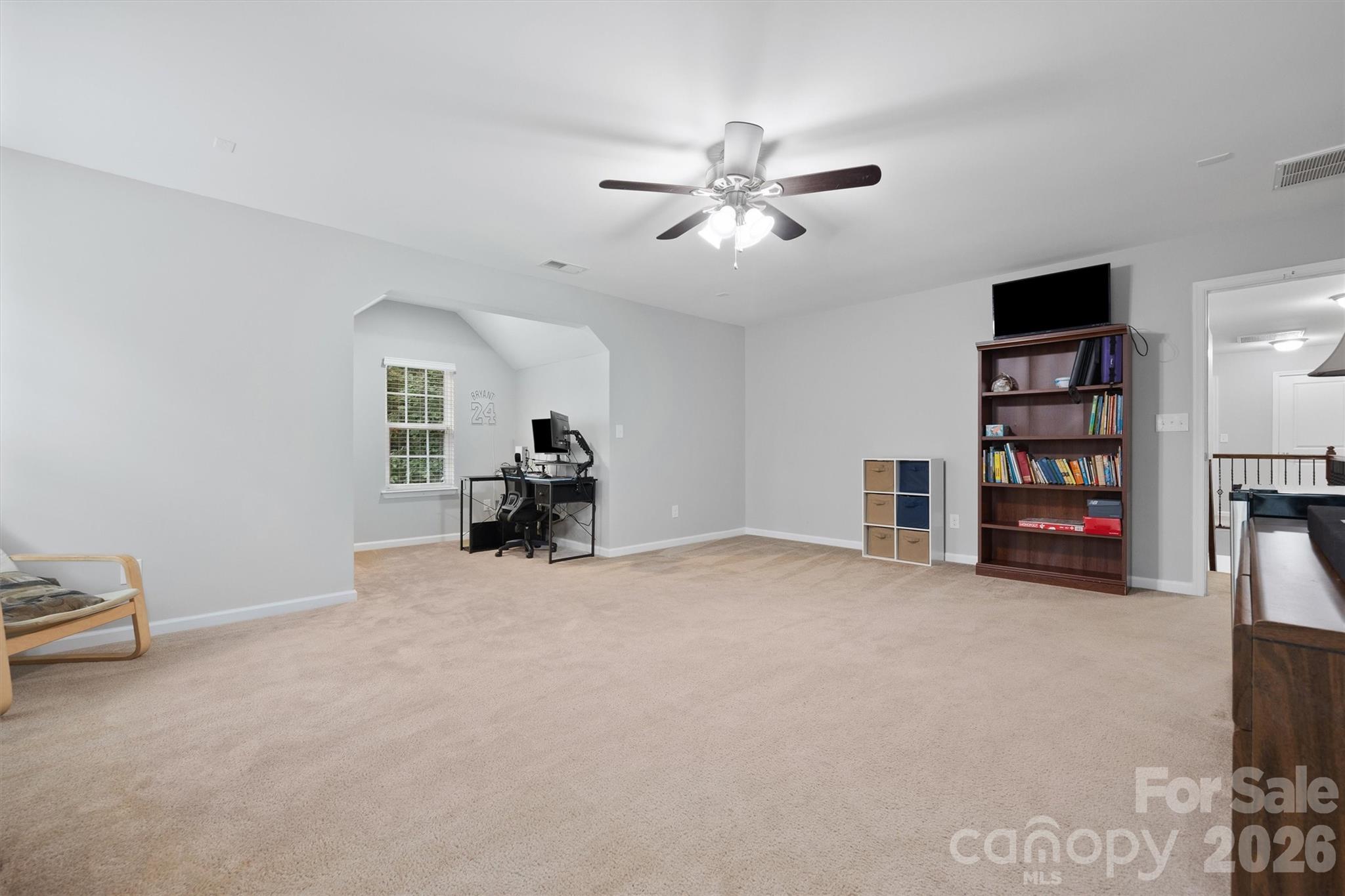 4237 Little Fork Cove Road Denver, NC 28037 - Photo 18 of 40 a view of a livingroom with a bookshelf and a window